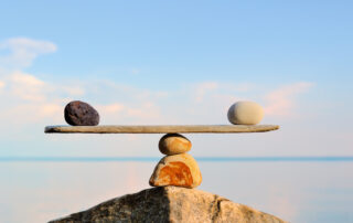 Pebbles balance on the top of the stone