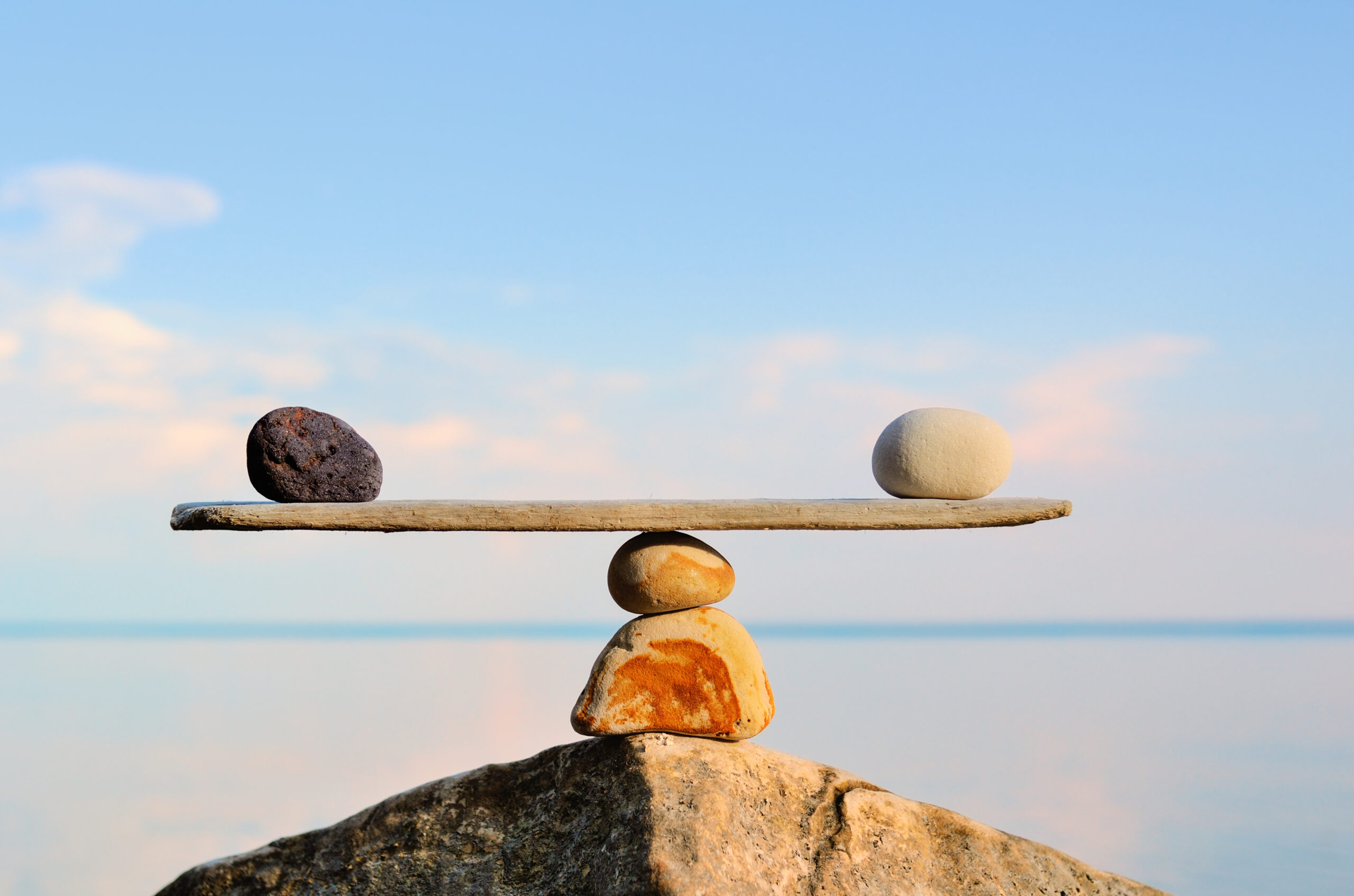Pebbles balance on the top of the stone